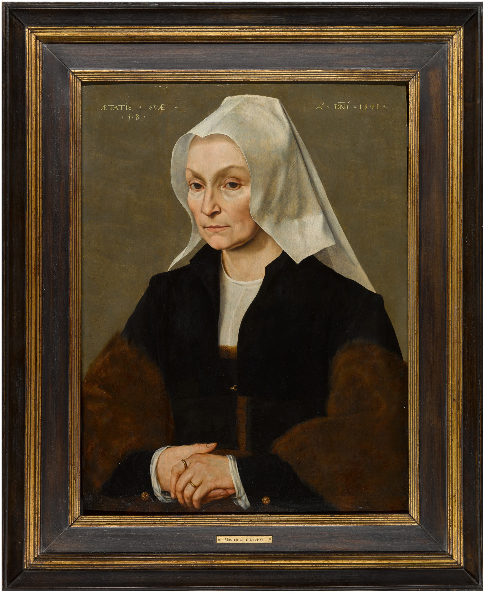 13 Portrait of a lady, half-length, wearing a black coat and fur wrap, with a white headdress.jpg