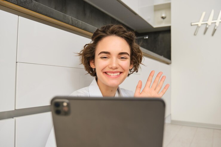 close-up-portrait-brunette-girl-smiles-looks-tablet-waves-camera-connects-online_1258-187245.jpg